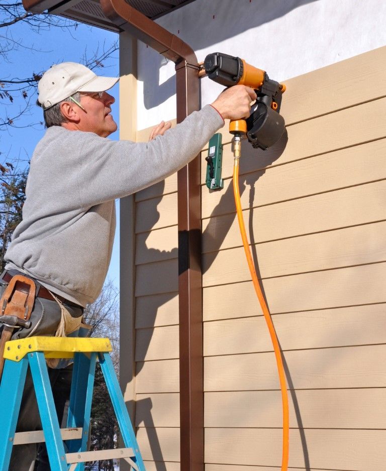 man installing fiber cement siding