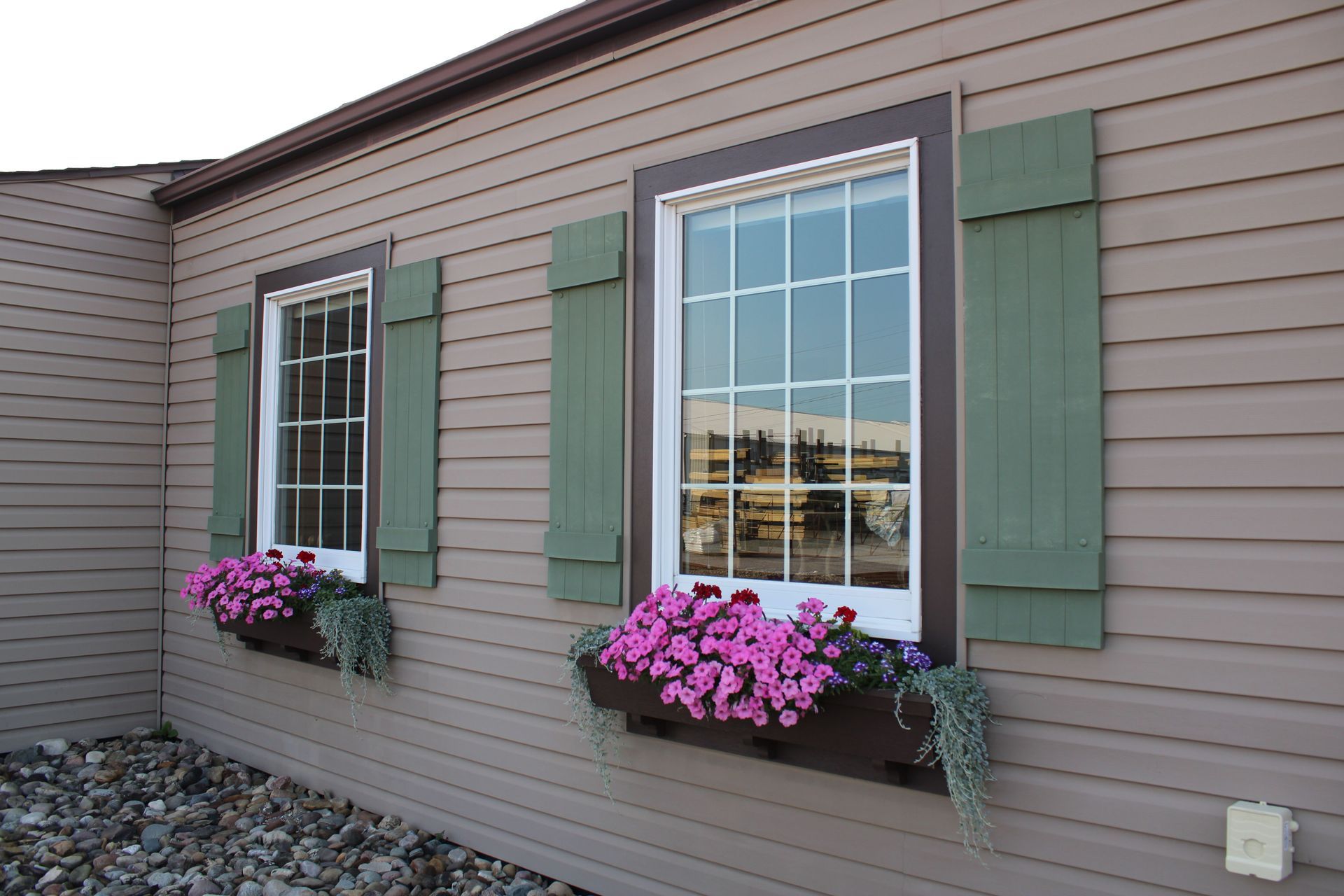 siding with two windows and flowers