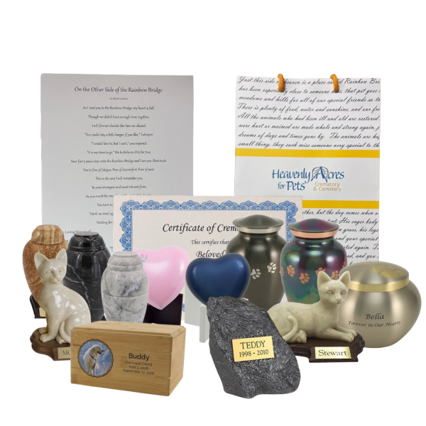 Memorial urns, keepsakes, and certificates arranged for pet remembrance, including paw-print boxes and engraved items