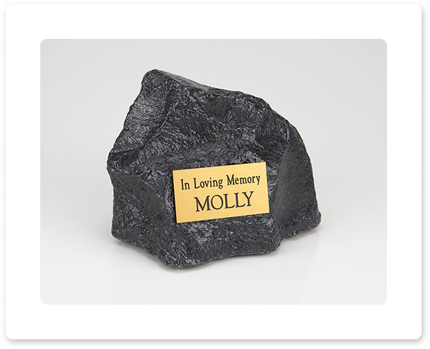 Black memorial stone with plaque reading 