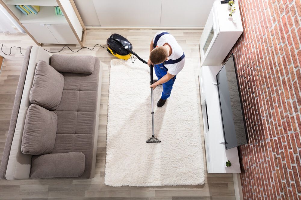 Worker Cleaning A Carpet — Healthy Cleaning Solutions in Nambucca Valley, NSW