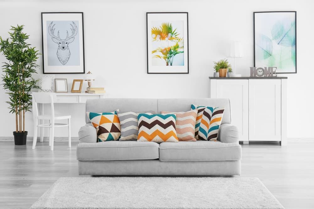 A Living Room with A White Couch and Colourful Pillows - Healthy Cleaning Solutions in Scotts Head, NSW