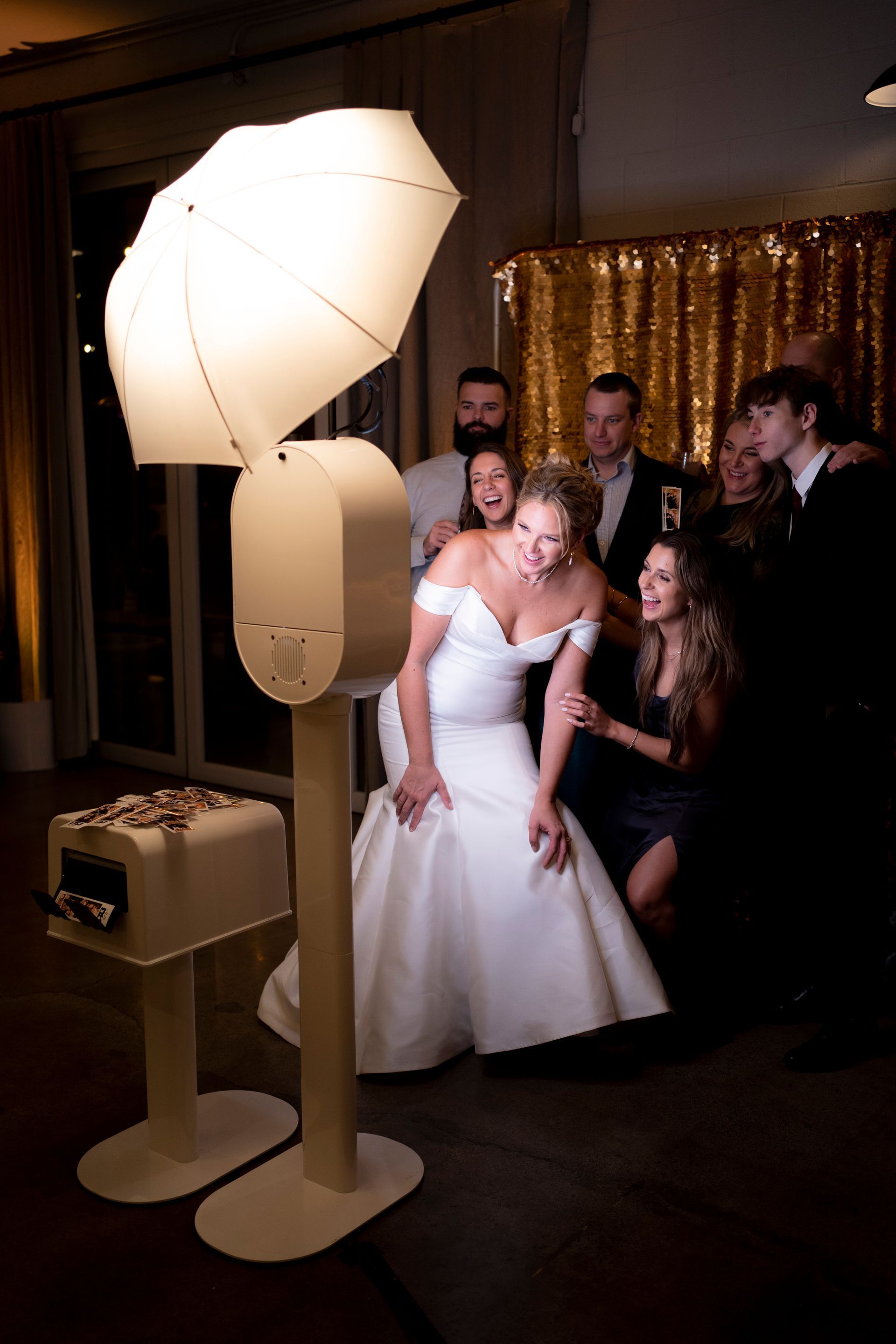 A bride is taking a picture of herself in a photo booth.