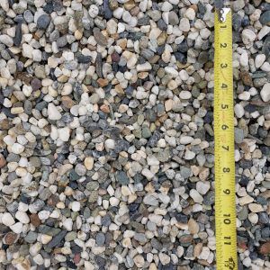 Assorted gravel stones with a yellow measuring tape along the right edge