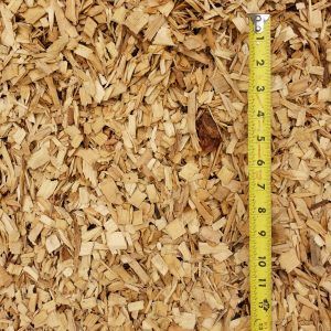 Wood chips with a yellow measuring tape along the right edge