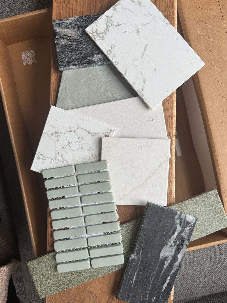 Cardboard box with assorted tile samples in white, gray, black, and green