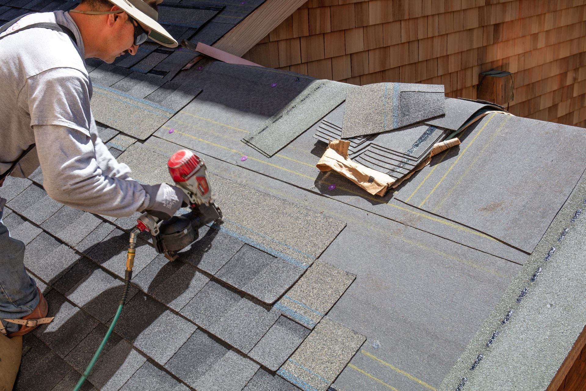 Male roof repair contractor working on a roof in Clayton, NC.