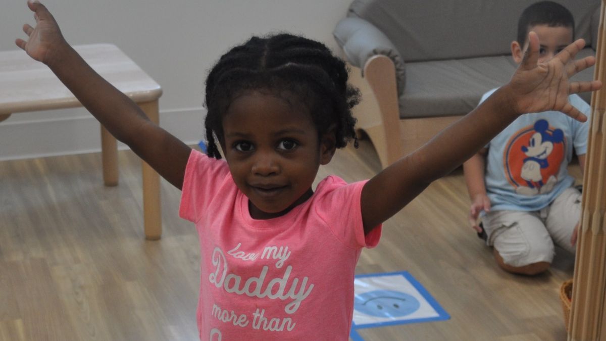 Little girl with her arms in the air