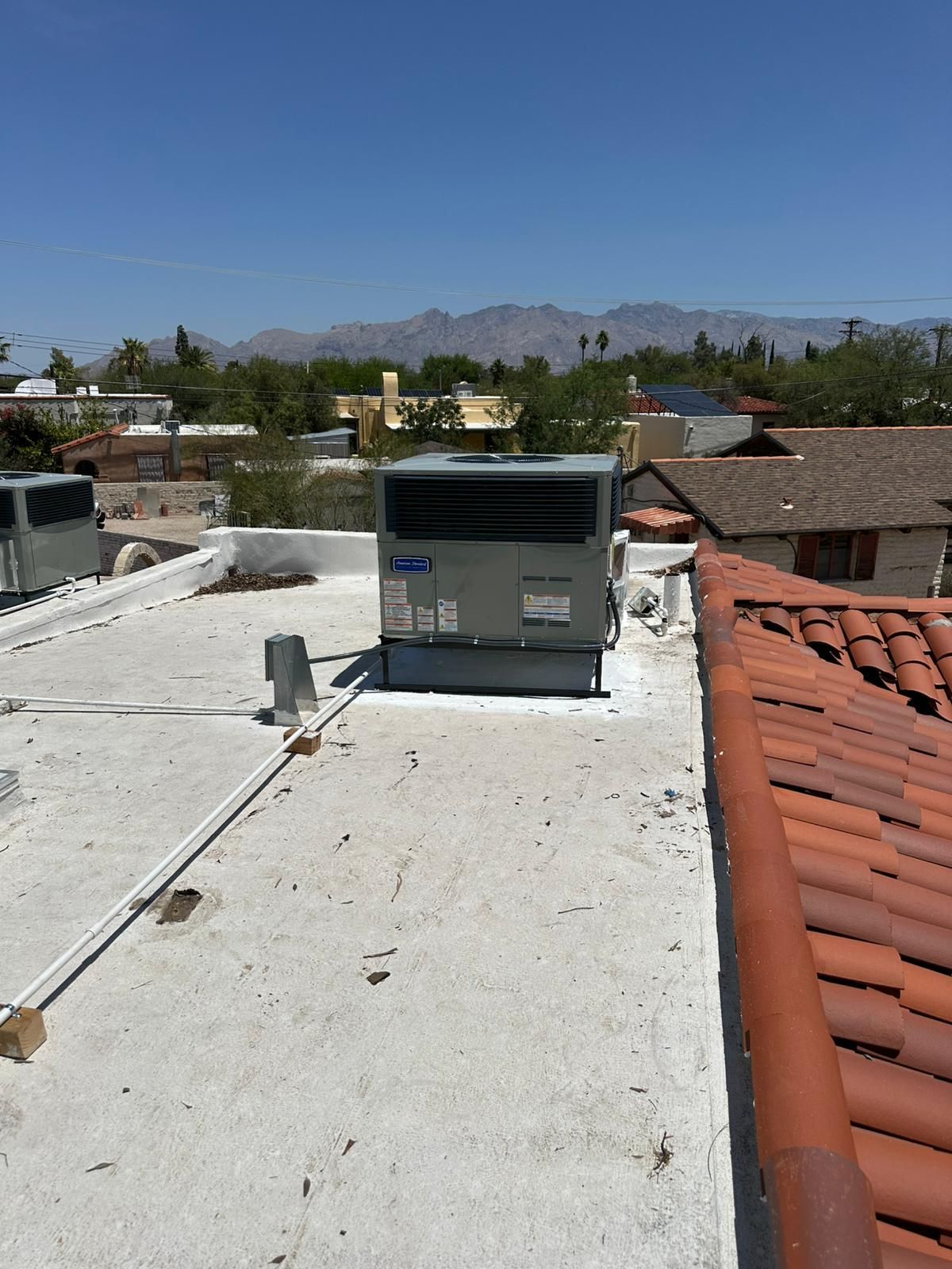 A rooftop with a carrier air conditioner on it