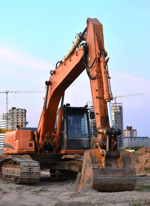 An Orange Excavator Sits on a Dirt Construction Site — Copp & Co Civil Plant Hire in Cannonvale, QLD