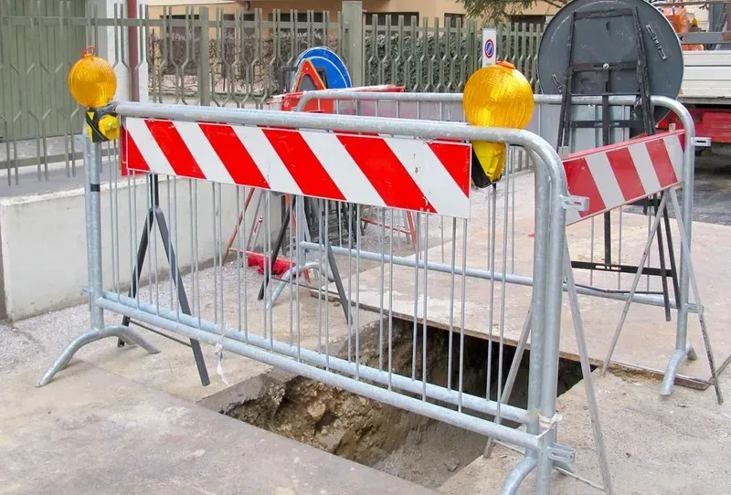 A Rectangular Hole in the Ground Cordoned Off by Metal Barriers — Copp & Co Civil Plant Hire in Airlie Beach, QLD