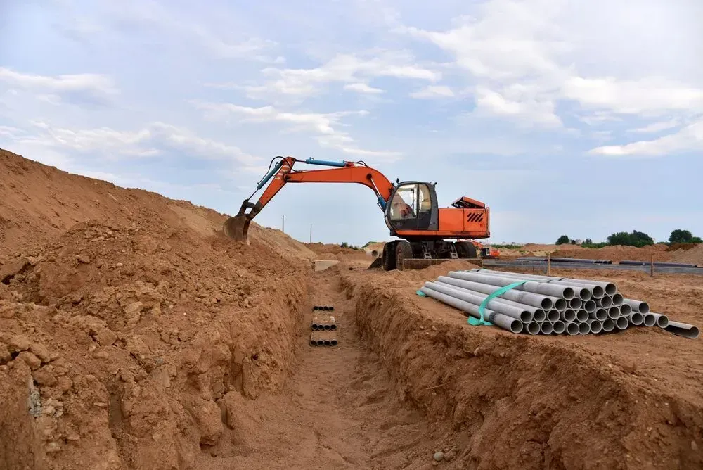 An Orange Excavator Sits on a Dirt Construction Site — Copp & Co Civil Plant Hire in Cannonvale, QLD