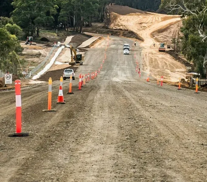 Construction Site on a Dirt Road, Lined With Orange Safety Bollards — Copp & Co Civil Plant Hire in Mount Julian, QLD