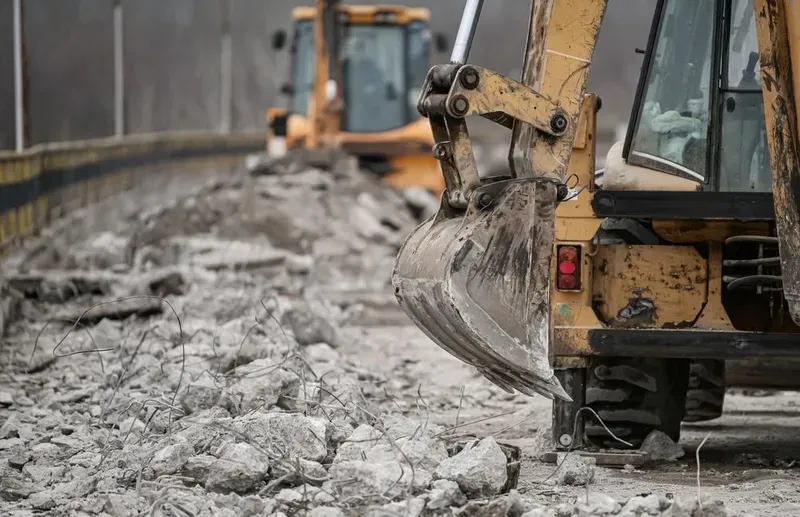Yellow Construction Machinery Working on a Pile of Rubble — Copp & Co Civil Plant Hire in Bowen, QLD