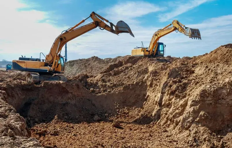 Two Yellow Excavators Sit Atop — Copp & Co Civil Plant Hire in Bowen, QLD