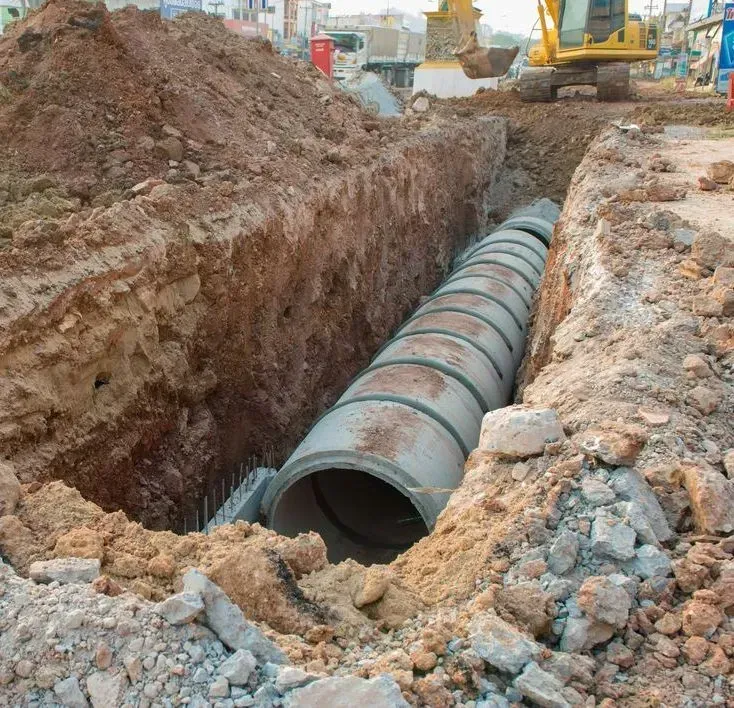 Large Concrete Drainage Pipes Installed in a Deep, Excavated Trench — Copp & Co Civil Plant Hire in Bowen, QLD