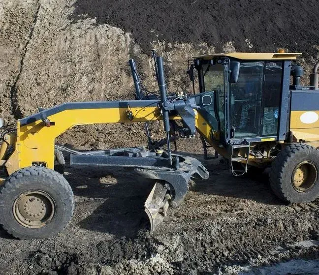 A Yellow and Dark Gray Motor Grader Parked on a Dirt Construction Site — Copp & Co Civil Plant Hire in Mount Julian, QLD