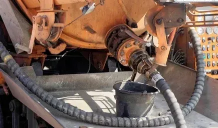 A Close-up of a Truck's Orange Tank Discharging Fluid — Copp & Co Civil Plant Hire in Mount Julian, QLD