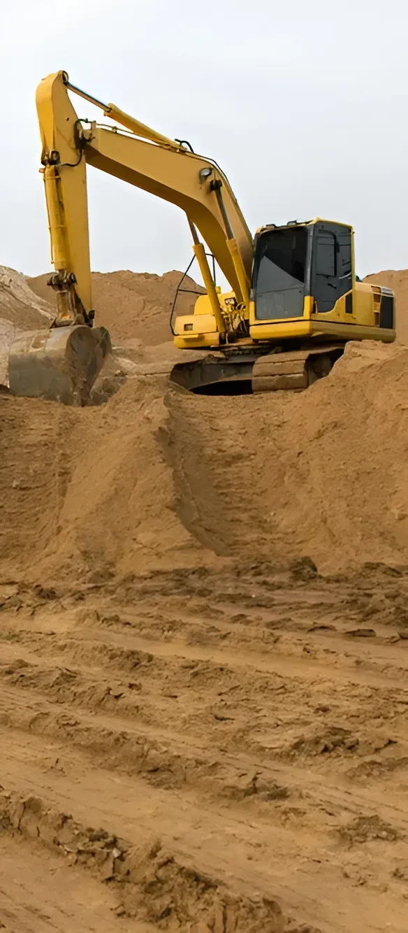 A Yellow Excavator Digging Into a Large Pile of Brown Sand — Copp & Co Civil Plant Hire in Mount Julian, QLD