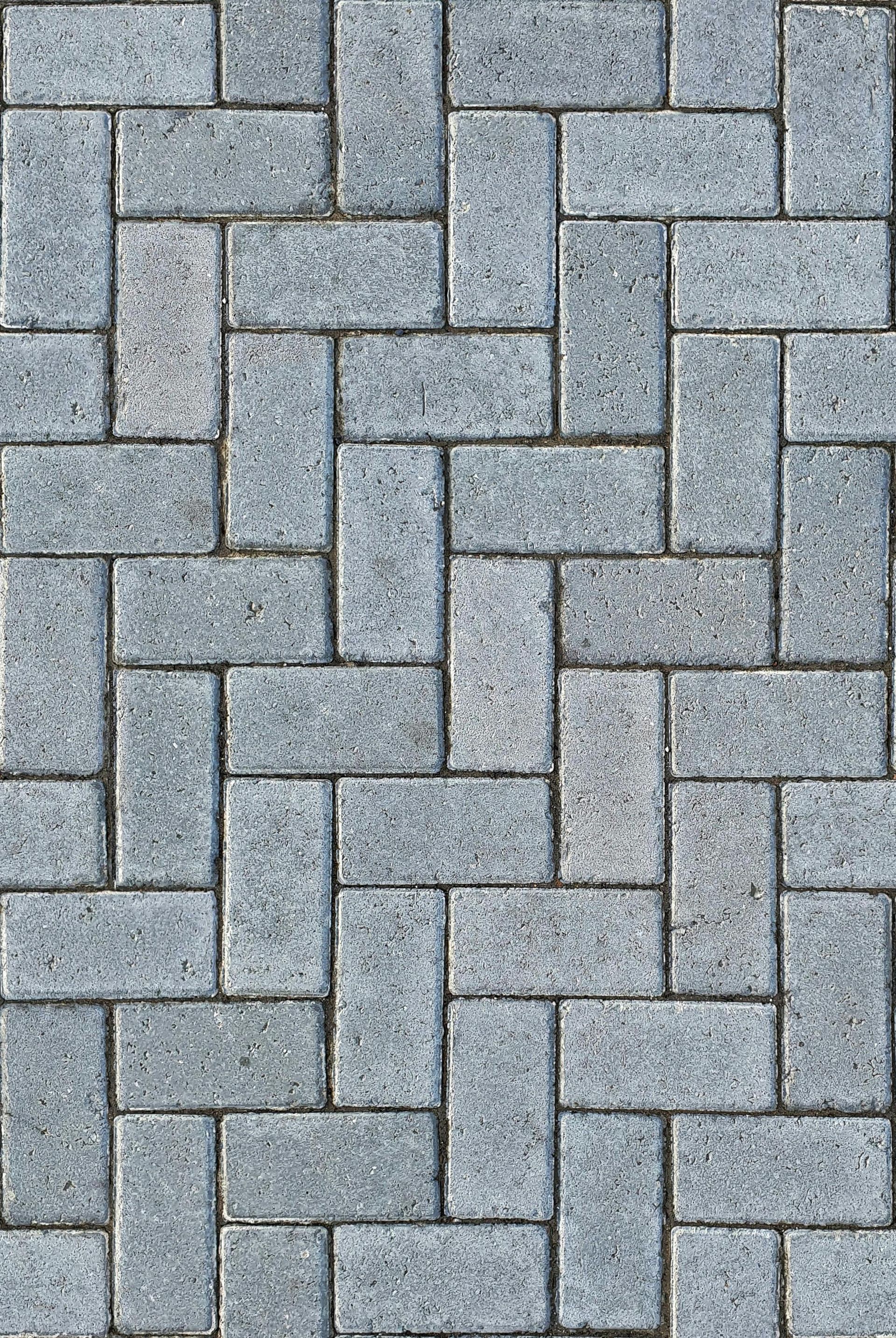 Gray interlocking brick pavers forming a patterned stone surface