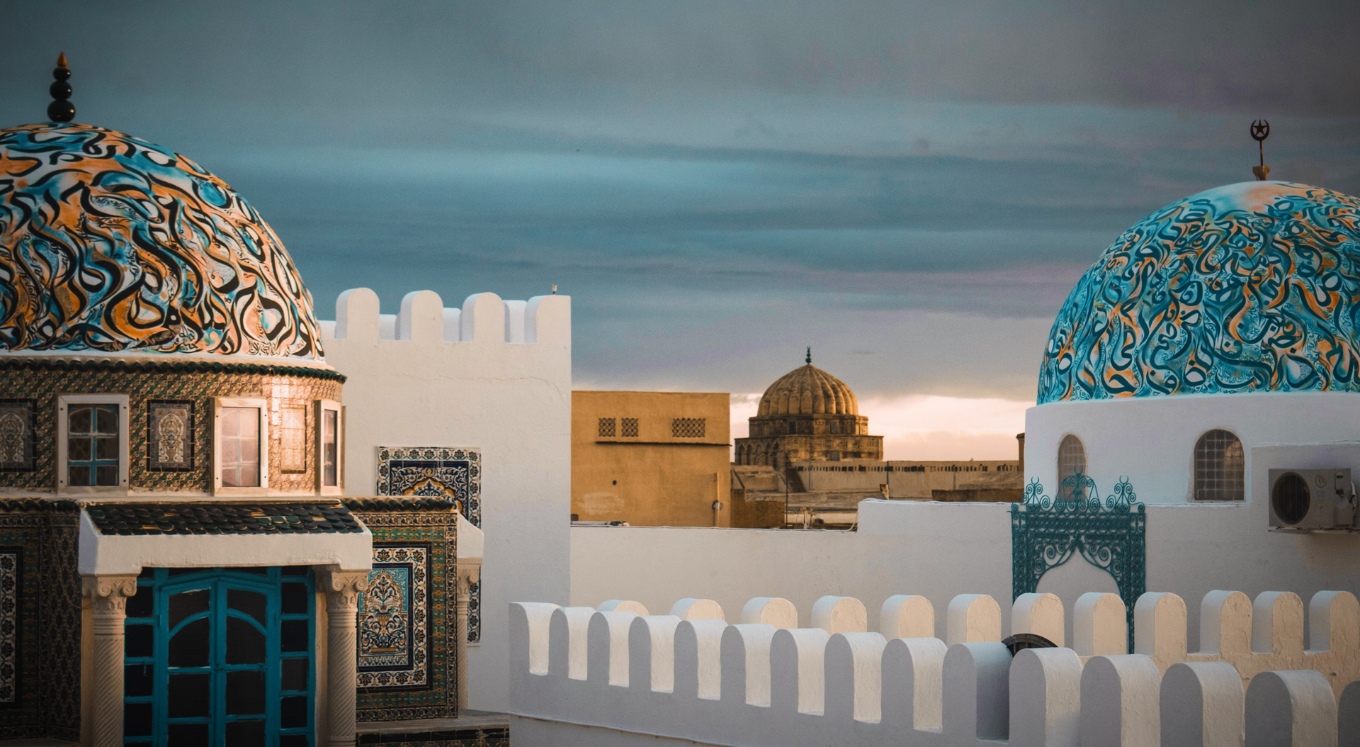 A white building with a blue dome on top of it.