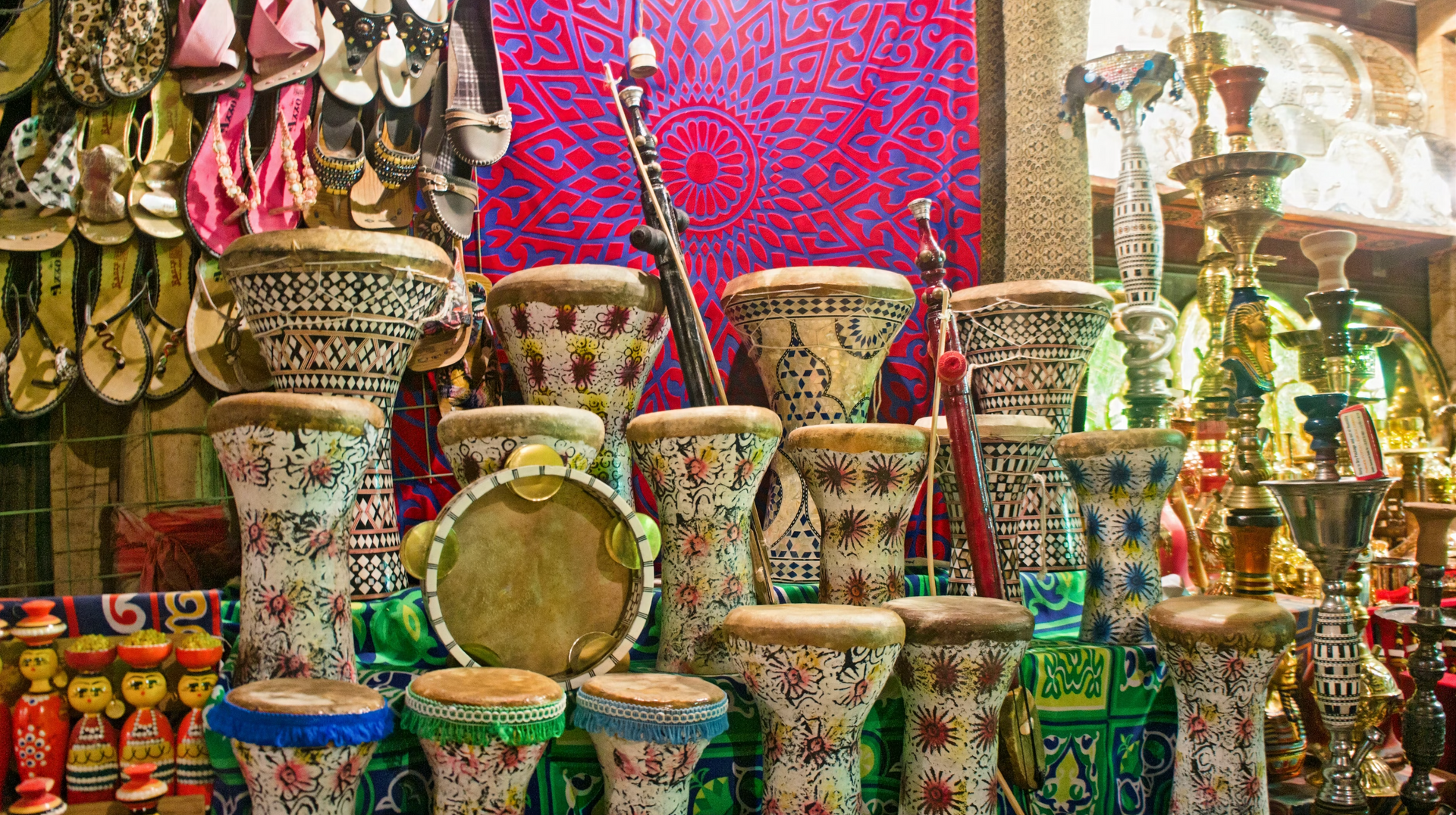 A bunch of drums are sitting on top of each other in a store.