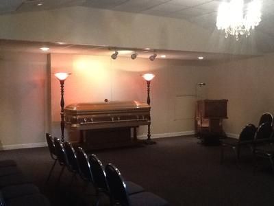 Dim banquet hall with a grand piano, chairs, and warm lamp lighting