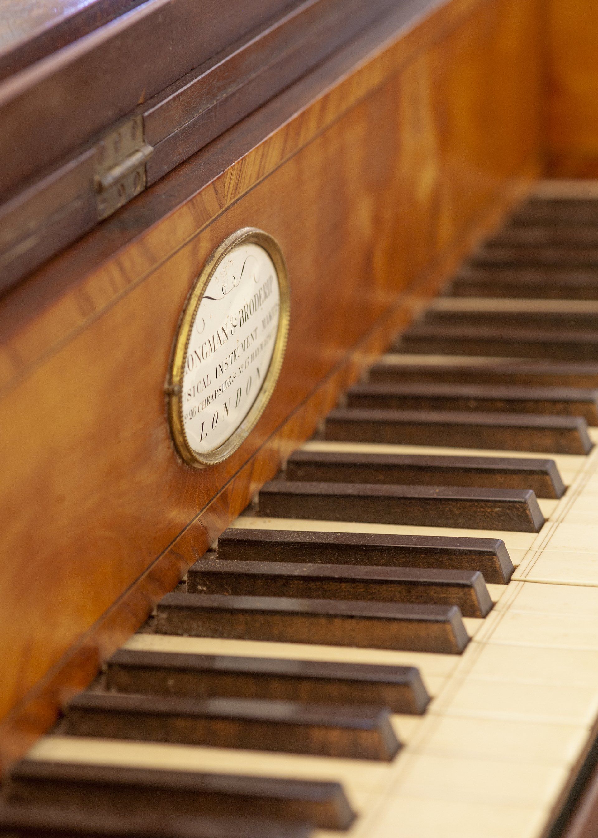 Een close-up van een pianotoetsenbord met een klok erop.