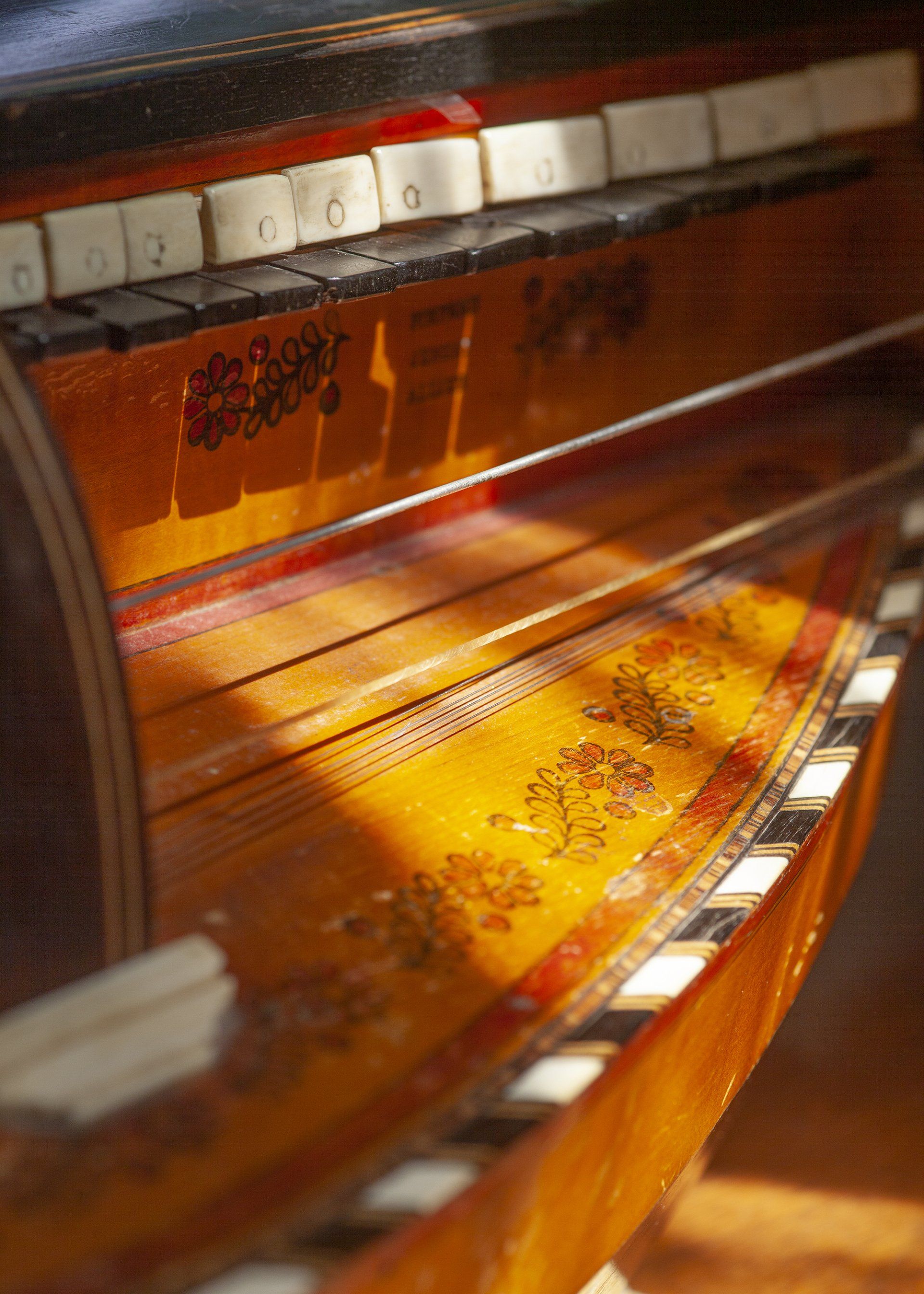 Een close-up van een piano met een bloemmotief erop