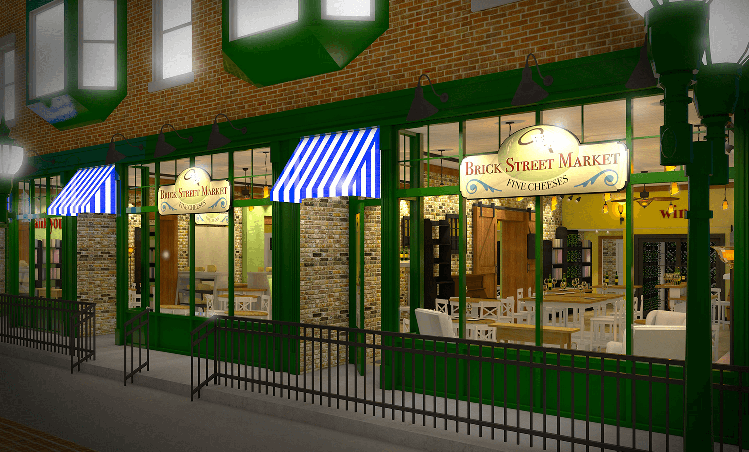 Brick storefronts with blue-and-white awnings and lit shop windows at night behind a green fence