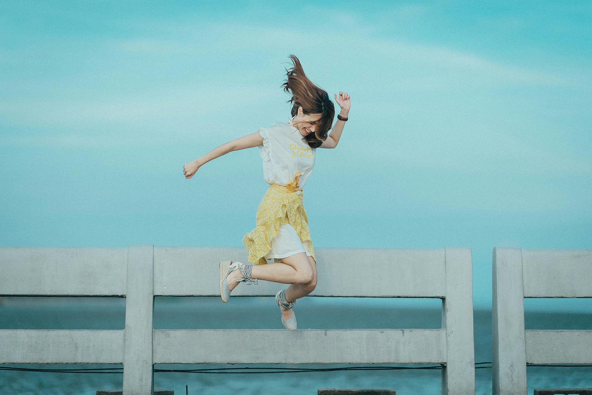 Photo of a happy woman jumping up for joy