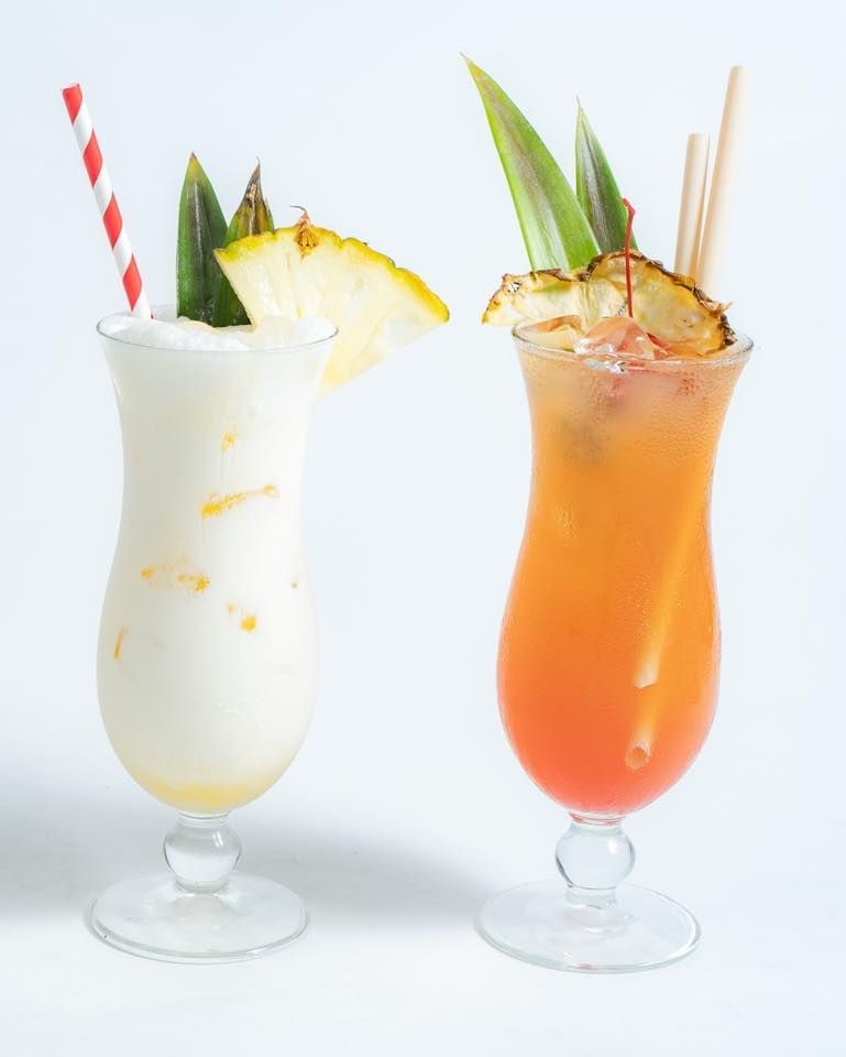 Two Glasses of Cocktails With Pineapple Slices and Straws — Gosford Sailing Club in Gosford, NSW
