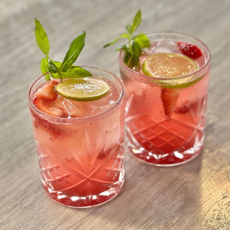 Two Glasses of Pink Liquid With Strawberries and Lime Slices — Gosford Sailing Club in Gosford, NSW