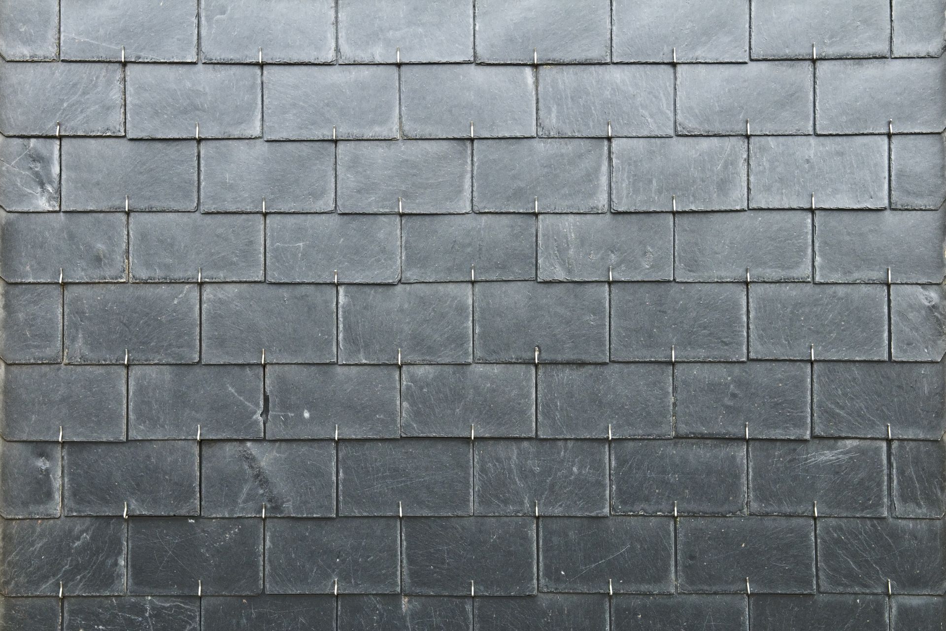 A close up of a black brick wall