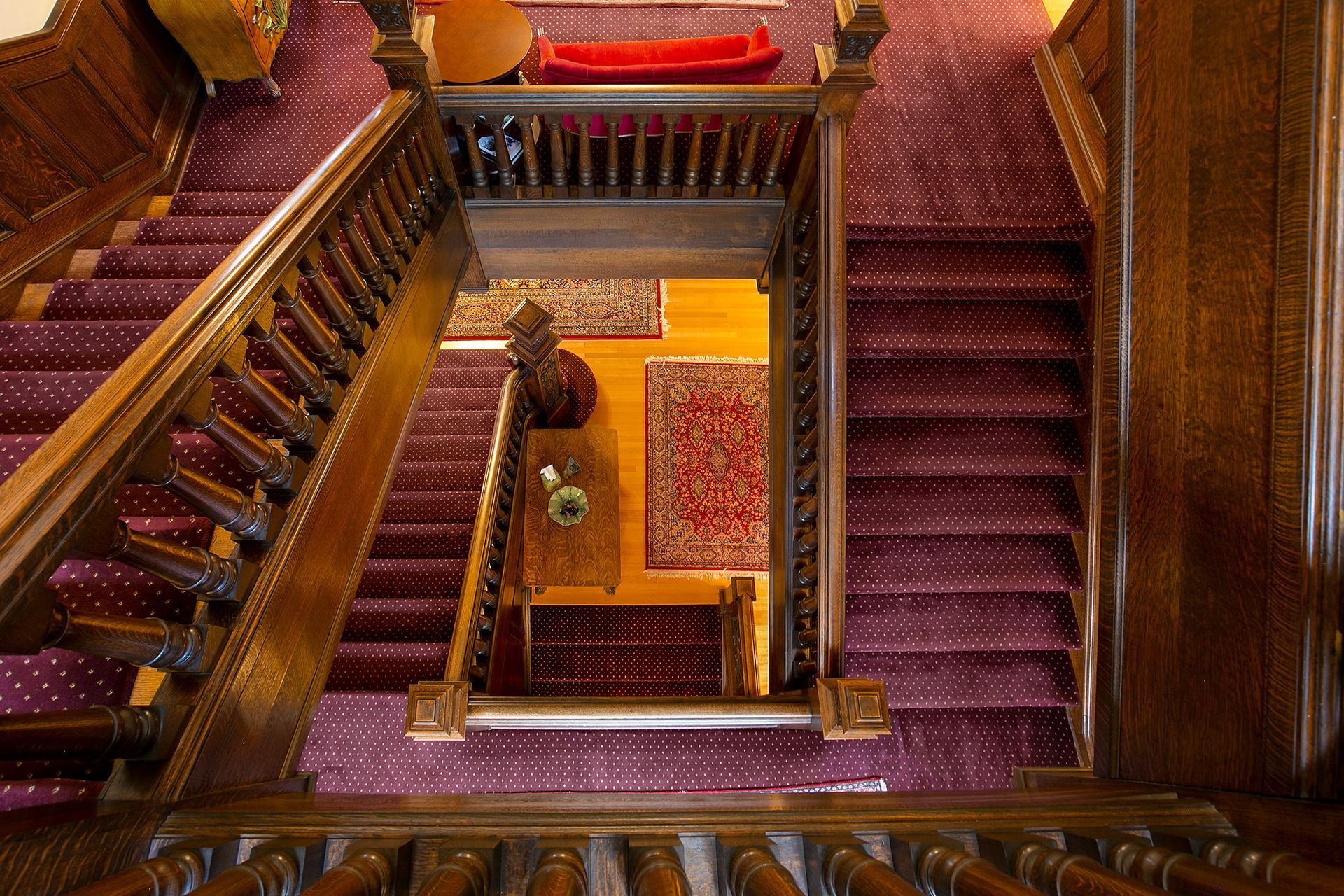 An aerial view of a staircase with purple carpet