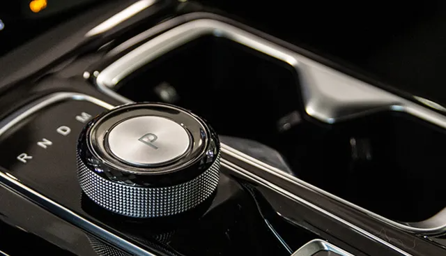 Manopola del cambio dell'auto in una console nera lucida, con la posizione