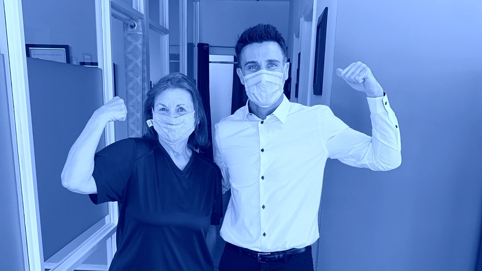 A man and a woman wearing face masks are posing for a picture.