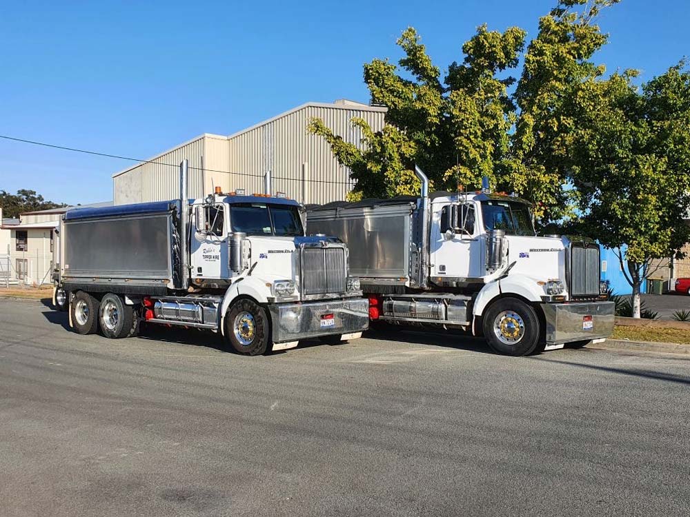 Two Tipper Trucks Parked Next To Each Other — Tipper Truck Hire In Port Macquarie, NSW