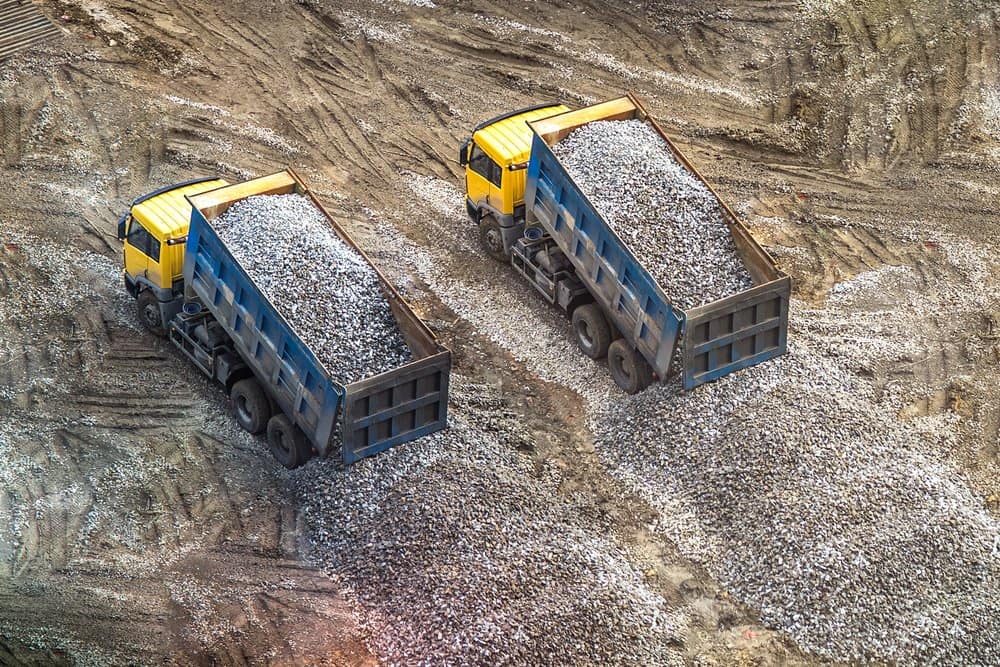 Two Tipper Trucks Unloading Gravel — Tipper Truck Hire In Port Macquarie, NSW
