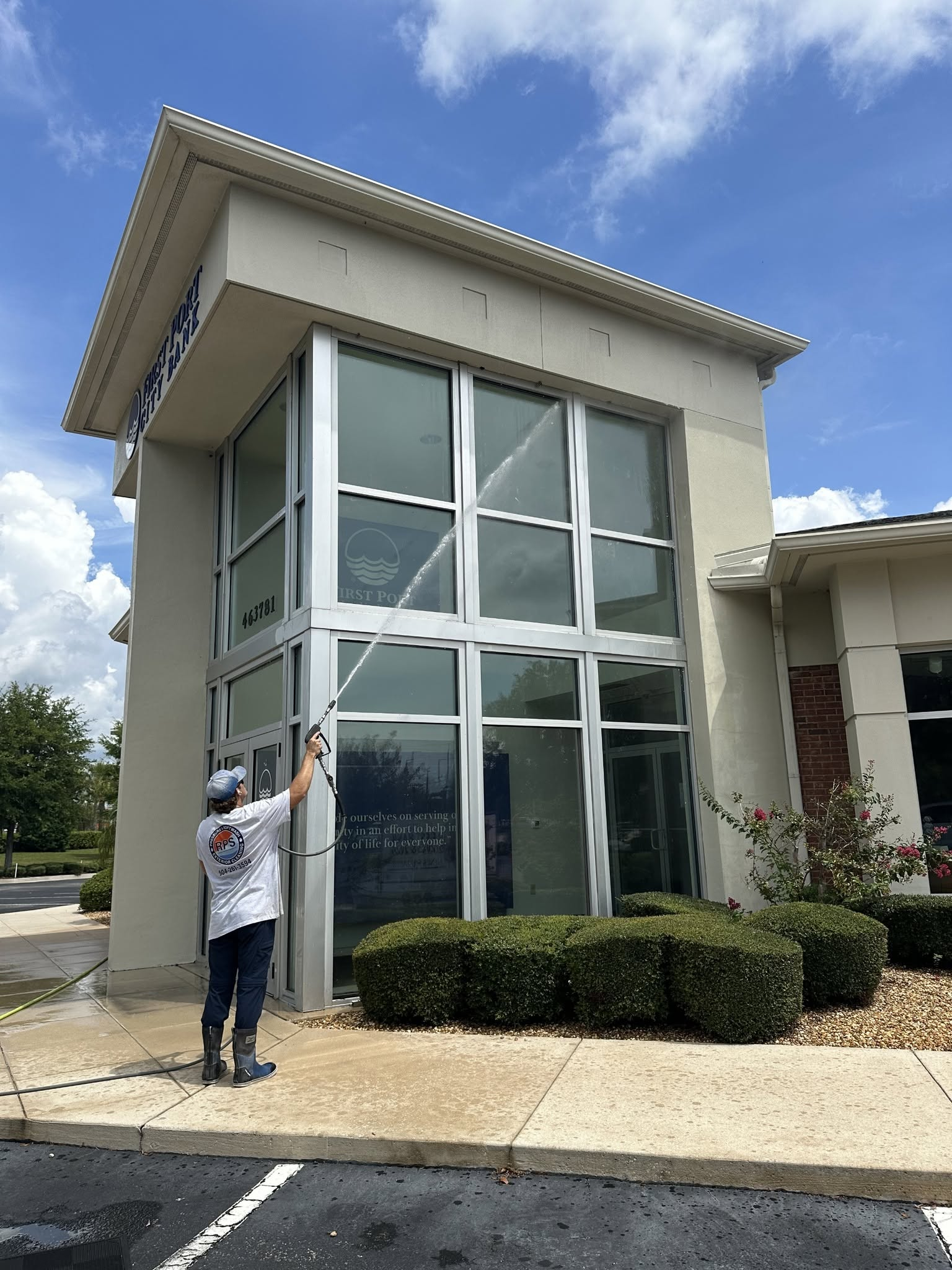 Pressure washing vinyl siding to remove dirt and grime from house exterior siding surface areas.