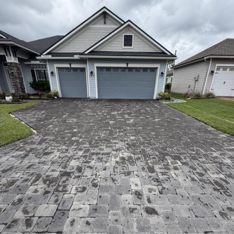 High-pressure system in action highlighting house pressure washing on a concrete surface. High-pressure system in action highlighting house pressure washing on a concrete surface.