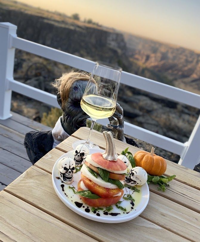 A plate of food and a glass of wine on a table