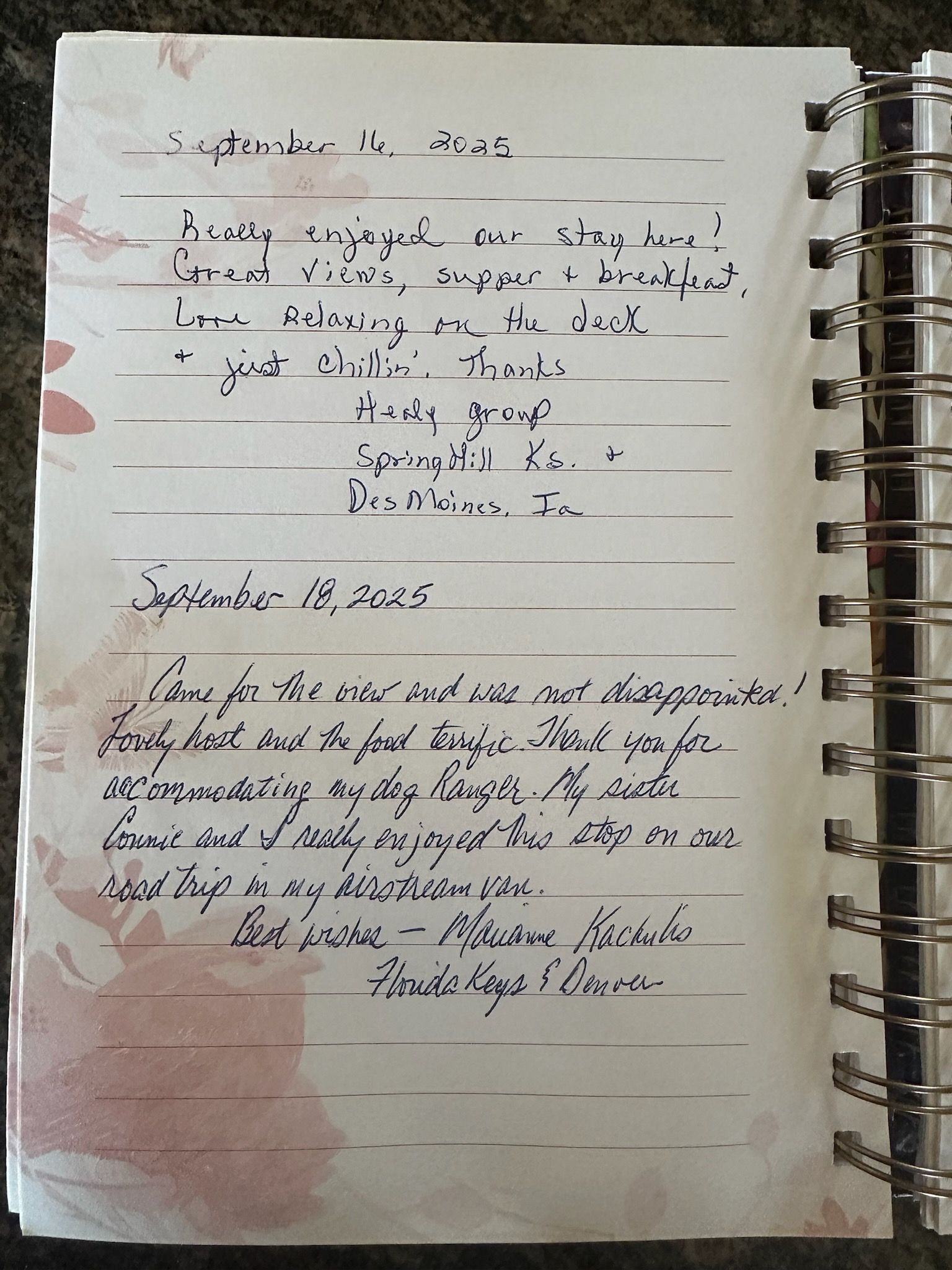 A spiral-bound notebook with handwritten entries dated September 11 and 15, 2022.