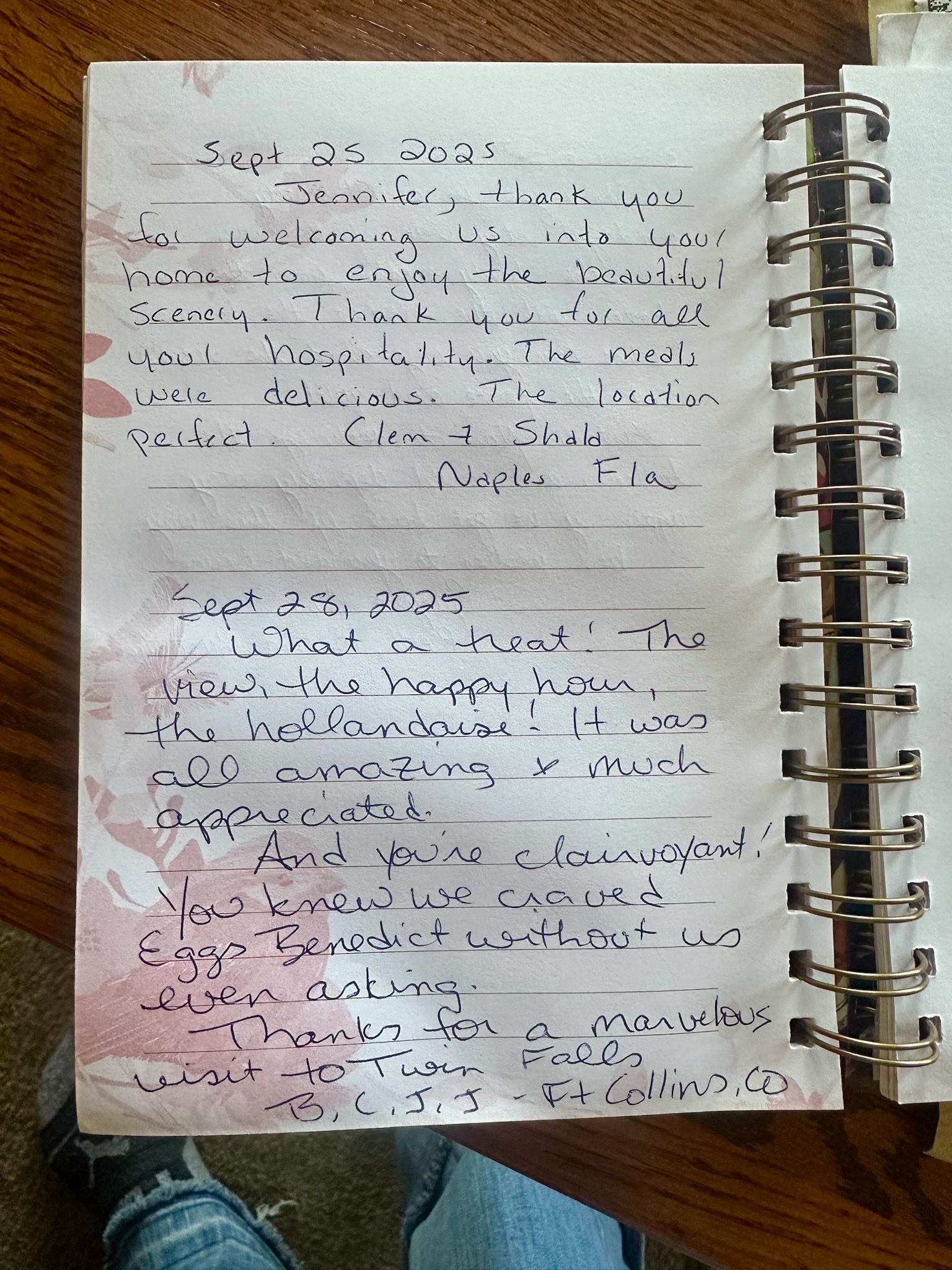Spiral notebook with handwritten text, stained paper, and a brown wood surface.