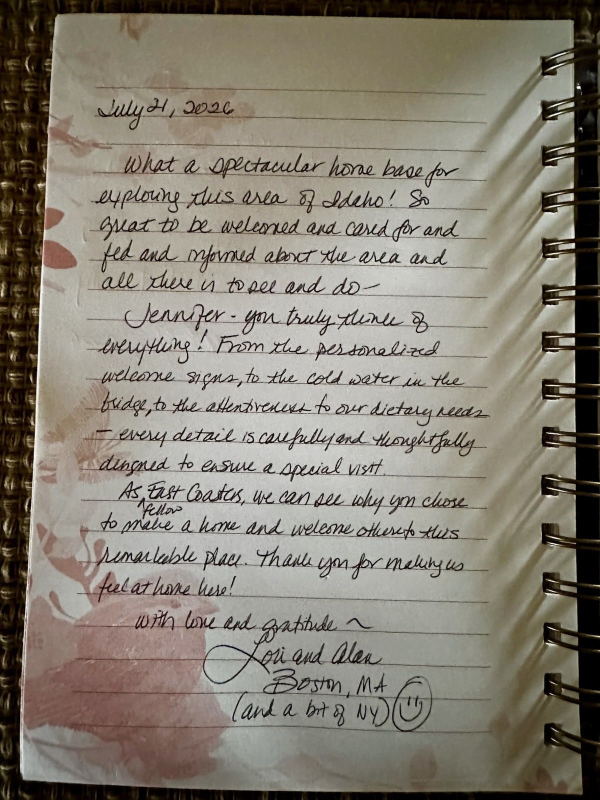 Handwritten note on lined paper with a red ink stain and a signature at the bottom.
