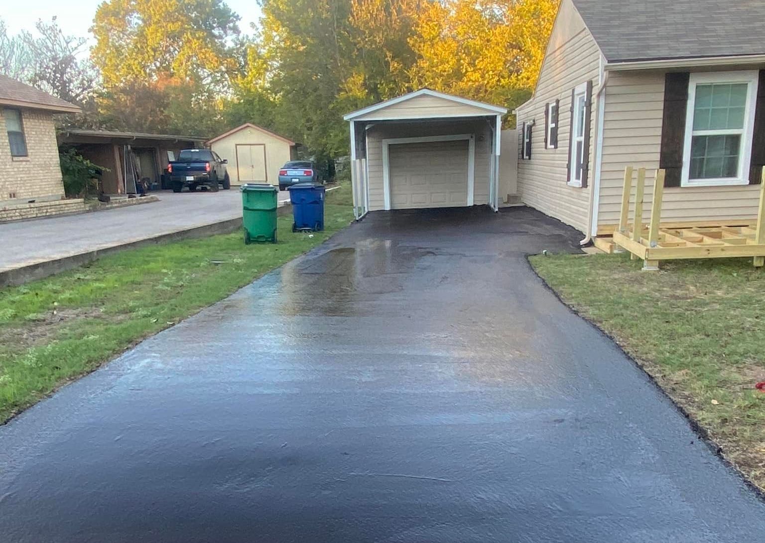 A shadow of a person is cast on the side of a road.