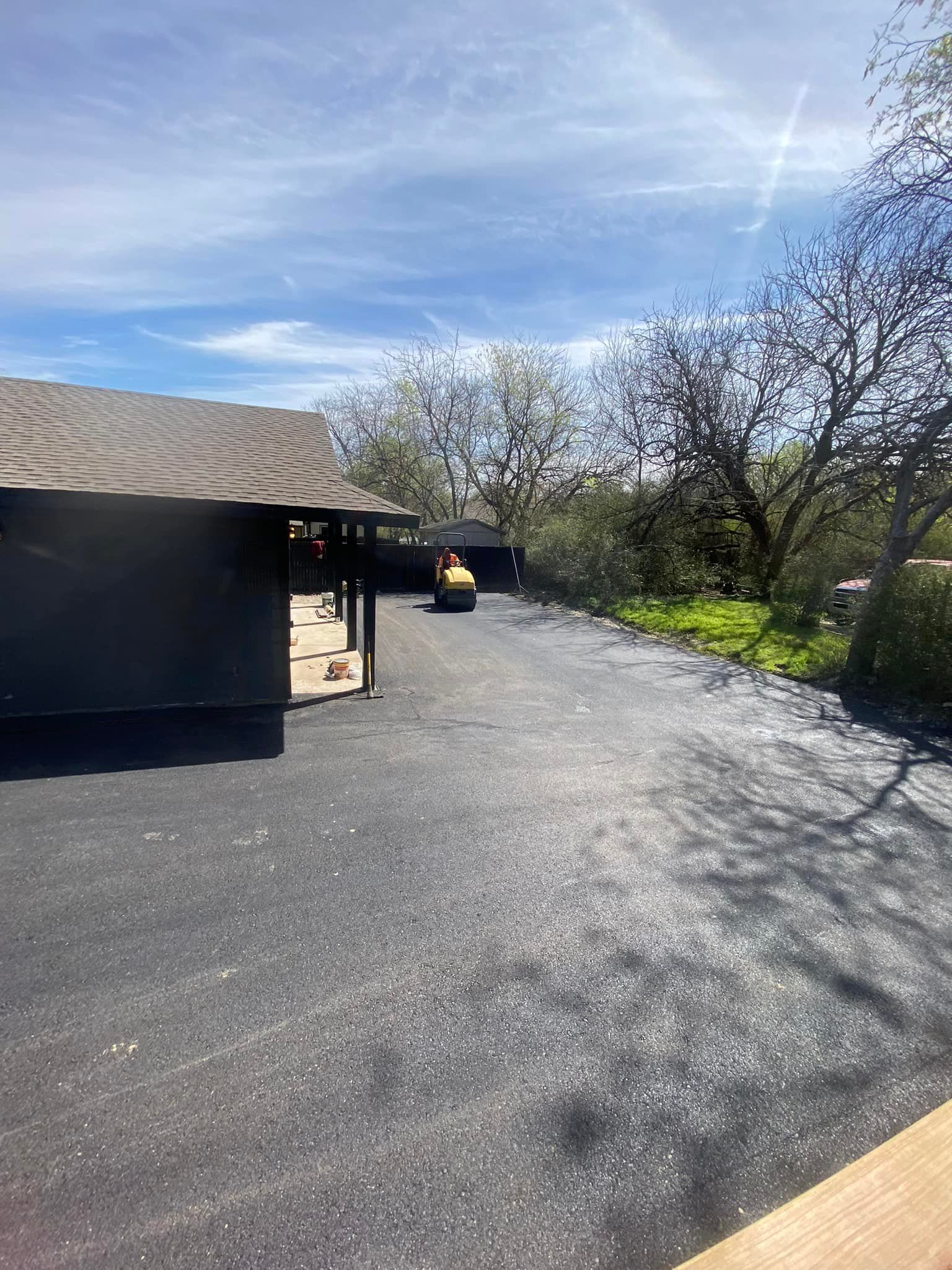 A car is parked in a driveway next to a house.
