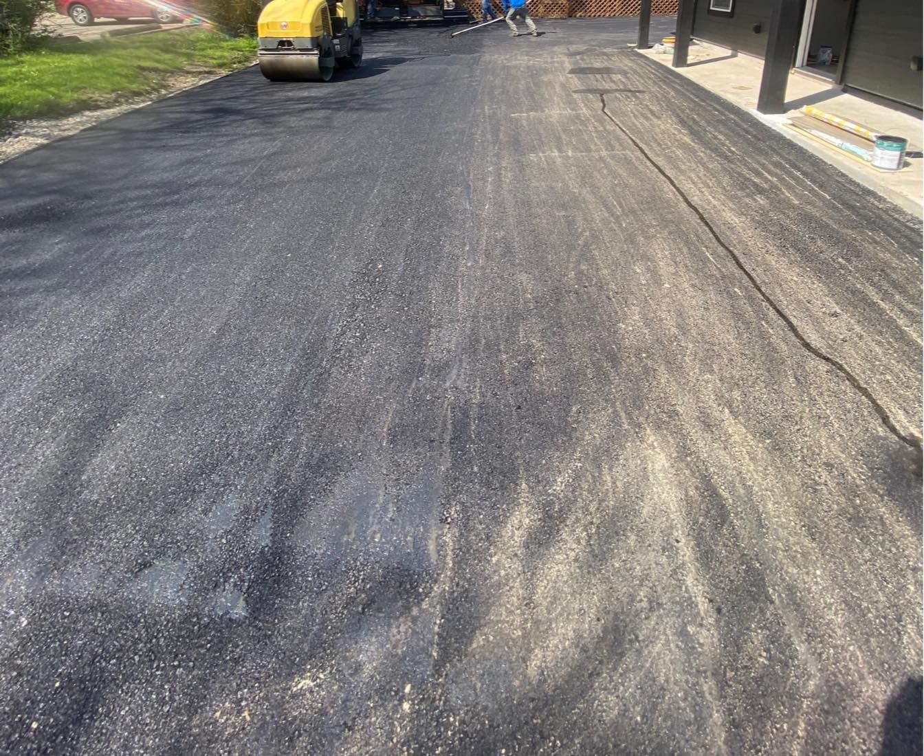 A roller is rolling asphalt on a road.
