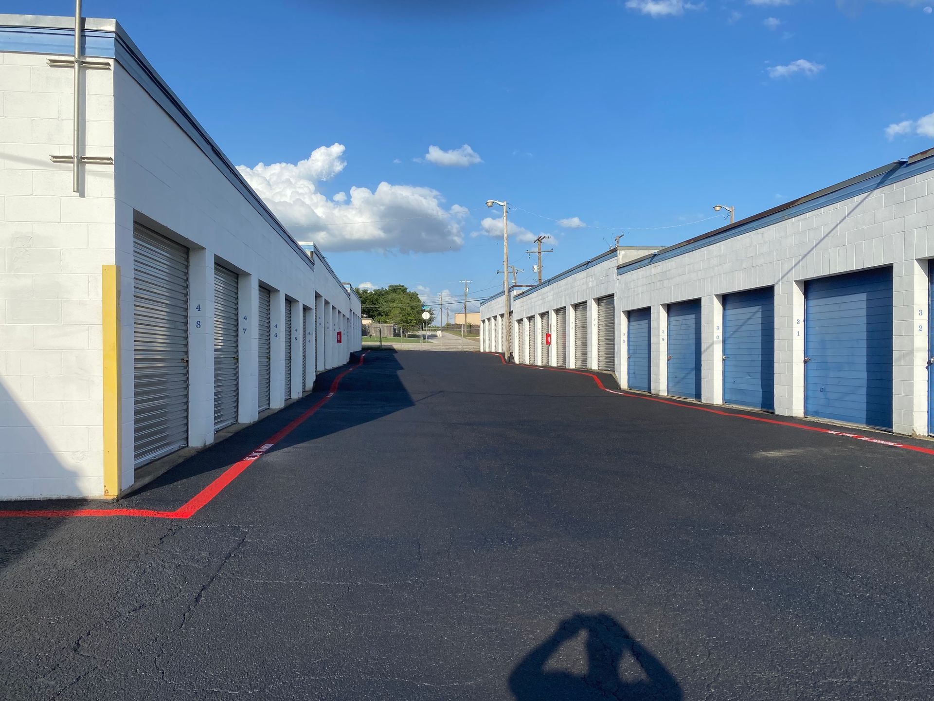A row of white buildings with blue garage doors
