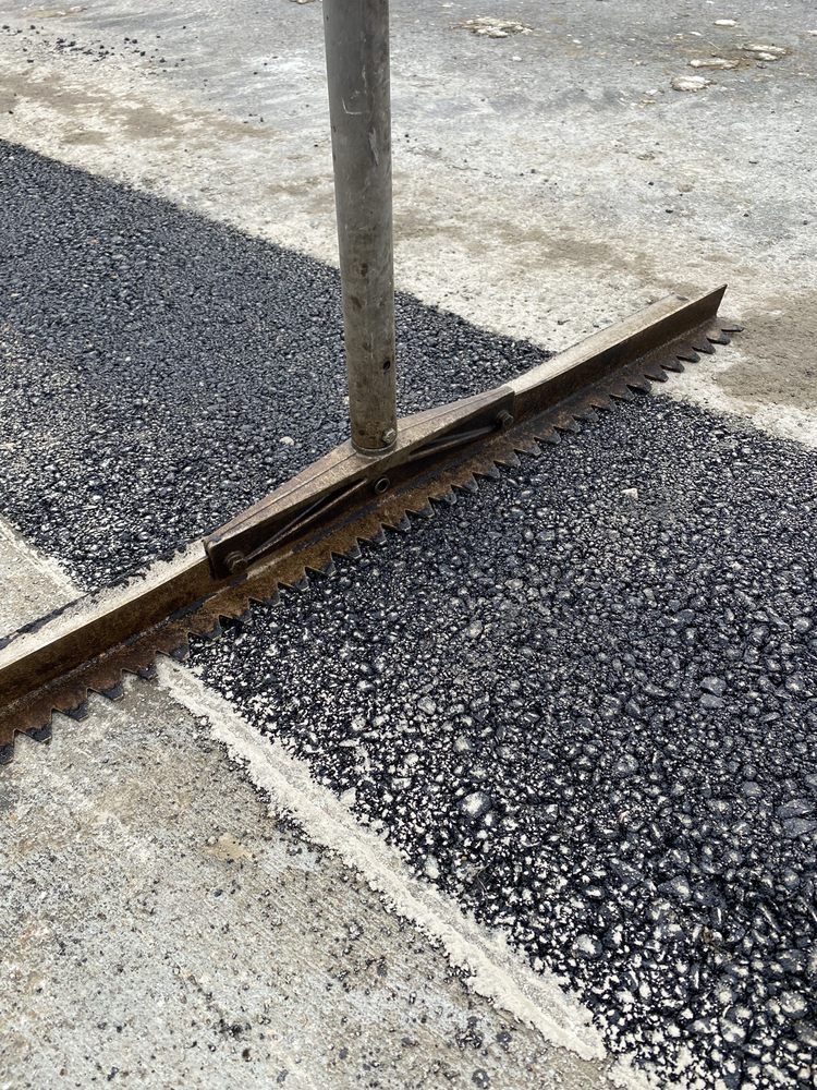 A close up of a road with a black line on it